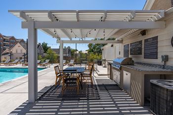 Patio with white pergola, tables and chairs